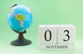 Planner wooden cube with numbers, 3 day of the month of November, autumn