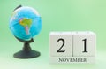 Planner wooden cube with numbers, 21 day of the month of November, autumn