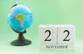 Planner wooden cube with numbers, 22 day of the month of November, autumn