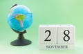 Planner wooden cube with numbers, 28 day of the month of November, autumn