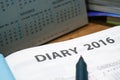 Daily planner year 2016 book on the wooden table Royalty Free Stock Photo