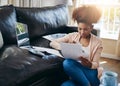 Planning, budget and black woman in home with bills, document and review investment report. Wealth, savings or person Royalty Free Stock Photo