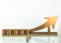 2020 Planning, Business and Goal Concept. Close up of wooden number blocks with wood arrow icon diecut with copy space