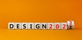 Planning 2022 design new year symbol. Turned a wooden cube and changed words `design 2021` to `design 2022`. Beautiful orange