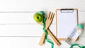 Planning for Diet Health eat and food.  Green Apple and measuring tape, note pad for fitness style. Royalty Free Stock Photo