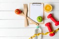 Planning for Diet Health eat and food.  Sport exercise equipment workout with fresh fruit, measuring tap, note pad for fitness sty Royalty Free Stock Photo