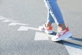 Planning future. Woman walking on drawn marks on road, closeup. White arrows showing direction of way Royalty Free Stock Photo