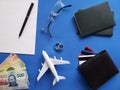 planning the honeymoon trip, rings, eyeglasses, mexican banknotes, passports, credit cards and figure of an airplane, top view