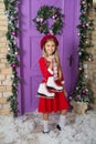 Planning an ice skating xmas party. Adorable girl skater on Christmas decoration. Little girl with pair of skates