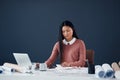 Planning my busy schedule for the rest of the week. an attractive young female architect working on a laptop in her Royalty Free Stock Photo