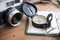 Planning next trip on table whith passport, vintage camera, compass, sunglasses and hat. Royalty Free Stock Photo