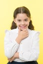 She is planning a prank. Girl school uniform smiling cunning face yellow background. Girl happy back to school. Child
