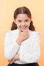 She is planning a prank. Girl school uniform smiling cunning face yellow background. Girl happy back to school. Child