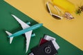 Planning, preparing for travel, vacation trip concept. Airplane with passports and tickets on a green background in front of beach Royalty Free Stock Photo