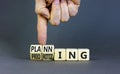 Planning and prioritizing symbol. Concept words Planning and Prioritizing on wooden cubes. Businessman hand. Beautiful grey