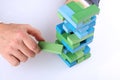 Planning, risk and strategy in business, businessman getting out a wooden block from a tower Royalty Free Stock Photo