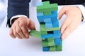 Planning, risk and strategy in business, businessman getting out a wooden block from a tower Royalty Free Stock Photo