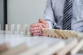 Planning Risk and Strategy in Business, Image of hand Businessman stopping and protection for collapse of wooden block game being Royalty Free Stock Photo