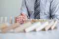 Planning Risk and Strategy in Business, Image of hand Businessman stopping and protection for collapse of wooden block game being Royalty Free Stock Photo