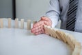 Planning Risk and Strategy in Business, Image of hand Businessman stopping and protection for collapse of wooden block game being Royalty Free Stock Photo