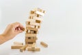 Tower of wooden blocks and human hands take one block. planning, risk and strategy in business. at the risk of taking a wooden blo