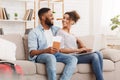 Planning tour. African-american couple using laptop at home Royalty Free Stock Photo