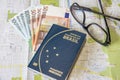 Planning a trip - Brazilian passport on city map with euro bills money and glasses