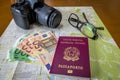 Planning a trip - Italian and Brazilian passports on city map with euro bills money, camera and glasses Royalty Free Stock Photo