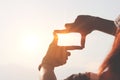 Planning and vision concept of new year's start, woman hands framed find focus at sunset