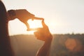 Planning and vision concept of new year's start, woman hands framed find focus at sunset