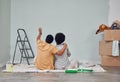 Planning, wall or black couple pointing in home renovation, diy or house remodel together on floor. Back view, painting Royalty Free Stock Photo