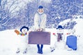 Planning winter vacations. Winter holiday. Winter World Travel. Happy young girl playing in fresh snow and making