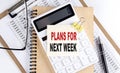 PLANS FOR NEXT WEEK word on sticky with clipboard and notebook, business concept