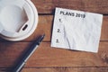 Plans for 2019 word on paper with pen and coffee cup on wooden t Royalty Free Stock Photo