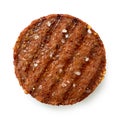Plant based grilled burger patty with grill marks and rock salt isolated on white. Top view Royalty Free Stock Photo