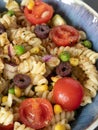 Plant-based vegan spicy pasta salad in a bowl made with fresh vegetables