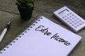 Plant,calculator,pen and notebook written with Extra Income on wooden background