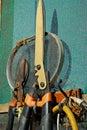 Plant clippers and trimmers hanging from the wall of a greenhouse.