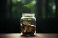 plant growing out of coins in the glass jar with green nature background, A glass jar full of coins and a little plant growing Royalty Free Stock Photo