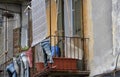 Plant pots placed in old trousers that are attached on railings of a  balcony Royalty Free Stock Photo