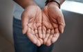 Plant a seed and watch it grow. a businessman standing with his hands cupped together.