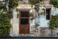 Plant and tree many species on old crack cement wall. Tree growing through cracked wall. Door and windows on the brick wall Royalty Free Stock Photo