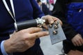 At the plant. Workers hands holding the spot welding gun and screws welded to the metal plate with use of spotter portable