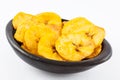Plantain fried coins in a traditional black clay bowl