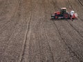 Planter sowing arable field with corn seeds