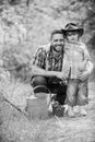 Planting flowers. Growing plants. Take care of plants. Boy and father in nature with watering can. Spring garden. Dad Royalty Free Stock Photo