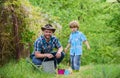 Planting flowers. Growing plants. Take care of plants. Boy and father in nature with watering can. Gardening tools. Dad Royalty Free Stock Photo
