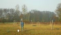 OLOMOUC, CZECH REPUBLIC, DECEMBER 15, 2019: Planting fruit trees on meadow near floodplain forest. White protects