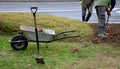 Planting perennials in the flowerbed in a transport growing pot. the gardener mulches with lava brown gravel which prevents the gr