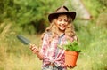 Planting plants. Happy childhood. Child in hat with shoulder blade small shovel hoe. Happy smiling gardener girl. Ranch Royalty Free Stock Photo